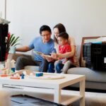 man and woman sitting on couch